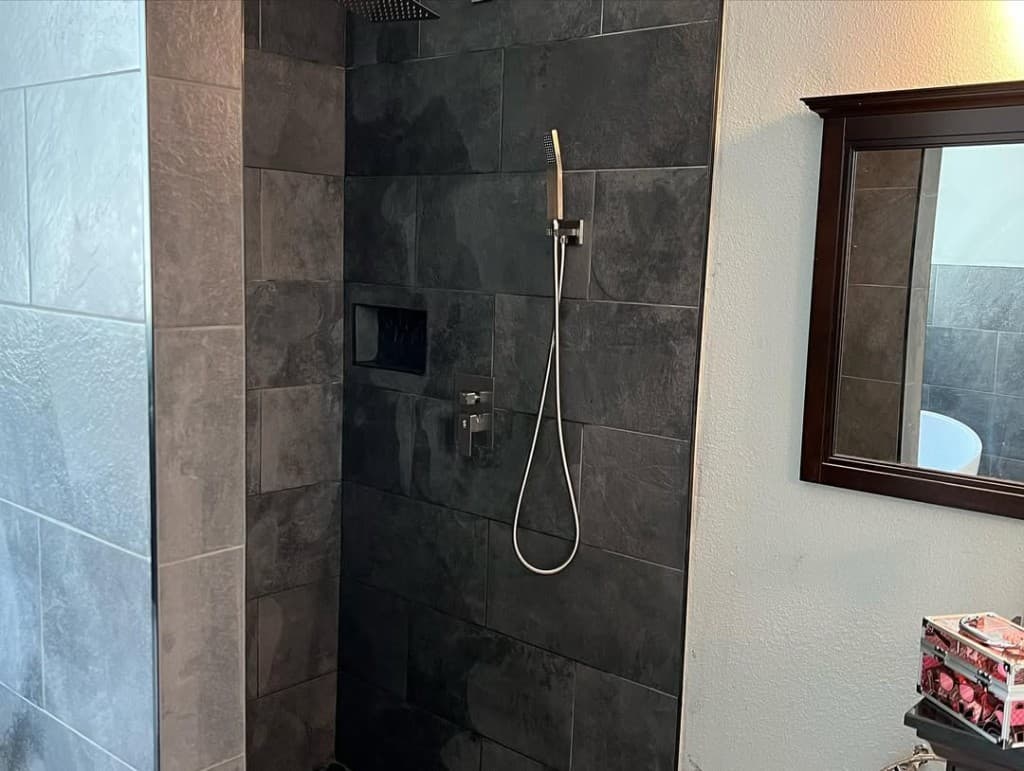 Walk shower large grey charcoal tile glass partition brushed handheld rail niche mirror reflecting tub corner pink case.